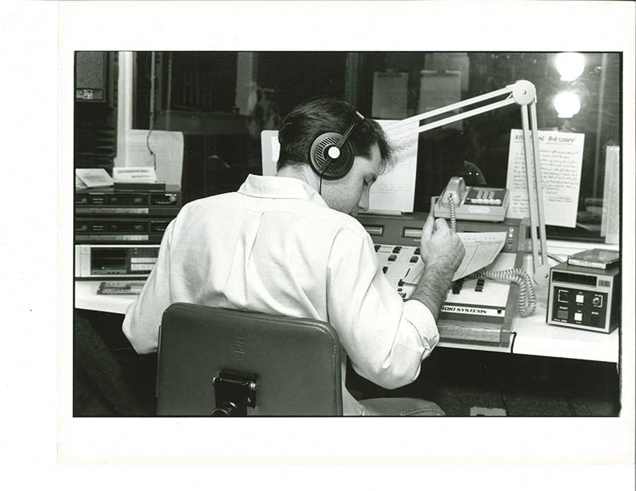 DJ with headphones at sound board